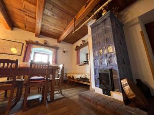 a dining room with a fireplace and a dining table at Penzion Stanský Mlýn in Hlinsko