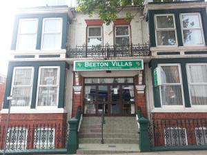 a building with a sign that reads be reborn villas at Beeton Villas Holiday Apartments in Blackpool