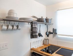 a kitchen with pots and pans on the wall at The Nightingale Motel in Pagosa Springs