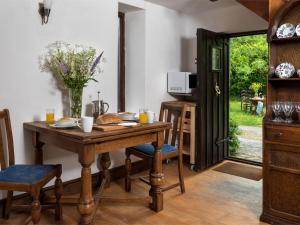 a dining room with a wooden table and chairs at 2 Bed in Cwmdu BN194 in Cwm-du