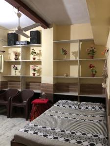 Habitación con cama y estanterías con altavoces en The Green House Impact en Jodhpur