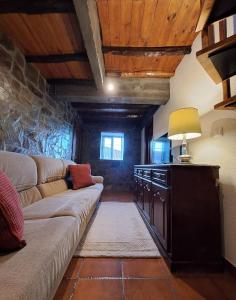 a living room with a couch and a table at BABhouse Lagar Antigo - Coração do Douro in Nagoselo do Douro