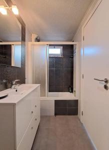 a bathroom with a sink and a shower with a window at BABhouse Lagar Antigo - Coração do Douro in Nagoselo do Douro