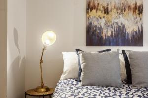 a bedroom with a bed and a painting on the wall at Broadgate Penthouse Apartment in Bradford
