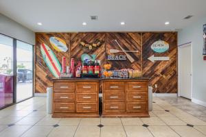 a restaurant with wooden walls and a counter at Beachside Resort Hotel in Gulf Shores