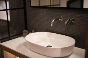 a white bathroom sink with a faucet on a counter at YOLO Resort - Loft in Alykes