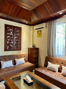 a living room with a couch and a table at Galayanee’s Resort Apartment in Seminyak