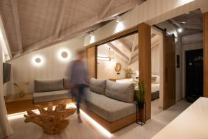 a man is running through a living room with a couch at YOLO Resort - Loft in Alykes