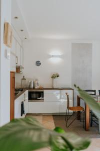 a kitchen with white appliances and a table and chairs at Lake House in Nago-Torbole