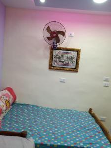1 dormitorio con 1 cama y ventilador en la pared en شقه بجوار البحر الهدوء والأمان شاطئ اكسجين, en Alejandría