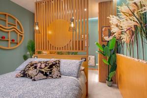 a bedroom with a bed and a wooden headboard at Napoli Suite Station in Naples