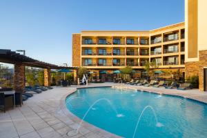 a hotel with a swimming pool in front of a building at Hampton Inn Carefree, Az in Carefree