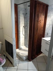 a shower with a glass door in a bathroom at 50 M OCÉAN maison classée 2 étoiles 2/7 personnes in Mimizan +7 photos