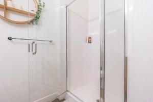 a shower with a glass door in a bathroom at Seattle Lux 1 bd Apartment- Rooftop, WiFi, Pet Friendly in Seattle +21 photos