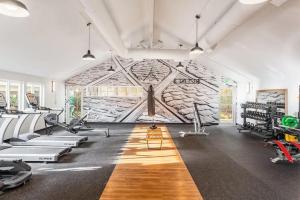 a gym with a stone wall and tread machines at Modern and spacious Apartment- Gym, Wifi, Free Parking in Seattle