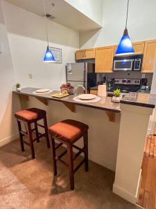 a kitchen with two bar stools and a counter top at Charming 2Bd/2bth Retreat in Downtown Richmond in Richmond