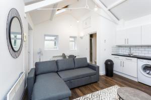 a living room with a couch and a sink at Stylish Self-Contained Annex near City Centre in Southampton