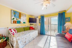 a living room with a couch and a tv at Makai 404 in Ocean City