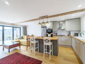 a kitchen and living room with a couch and a table at The Hive - Pet Friendly House - Emsworth in Emsworth