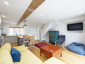 a living room with a couch and a table at The Hive - Pet Friendly House - Emsworth in Emsworth
