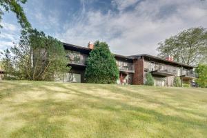 an apartment building with a lawn in front of it at Elegant 4-Season Lake Geneva Condo with Fireplace! in Lake Geneva