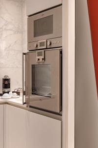 a microwave oven sitting on top of a kitchen counter at H&ocirc;tel Le Royal Monceau Raffles Paris in Paris