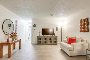 a living room with a couch and a television at Centrally Located Apt about 2 Mi to University of Iowa in Iowa City