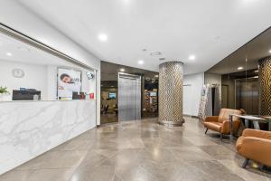 a lobby of a store with chairs and a counter at APX World Square in Sydney