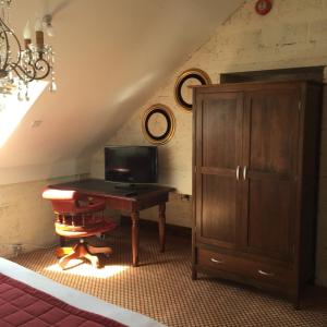 an attic room with a desk and a cabinet at Tides Apartments Liscannor in Liscannor