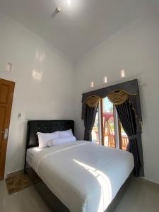Postel nebo postele na pokoji v ubytování Homestay Telage Bulan