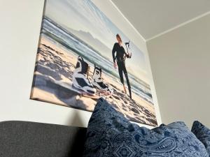 ein Schlafzimmer mit einem Bild eines Surfers am Strand in der Unterkunft WEITBLICK APARTMENT direkt am Park mit kostenlosem Parkplatz in Bremerhaven