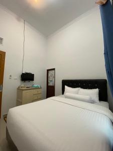 Postel nebo postele na pokoji v ubytování Homestay Telage Bulan