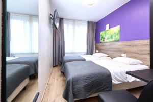 Postel nebo postele na pokoji v ubytování Hotel City Center