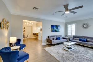 a living room with blue furniture and a ceiling fan at Sunny El Paso Apartment with Backyard Patio! in El Paso