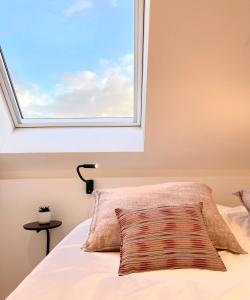 a bedroom with a window above a bed at MOLO roof - stylish penthouse with marina view Blankenberge within walking distance from the sea - 15 km from Bruges in Blankenberge