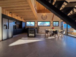 a kitchen and dining room with a table and chairs at La belle grange in Mercury