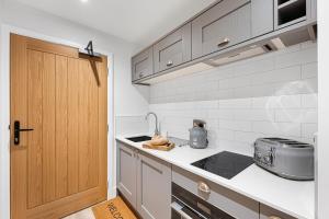 a kitchen with a sink and a stove at The Haddon Studio - Apartment 7 in Tideswell