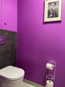 a purple bathroom with a toilet and a purple wall at Studio Les Champs in Baelen +41 photos