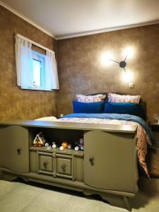 a bedroom with a bed with a drawer under it at Studio Les Champs in Baelen