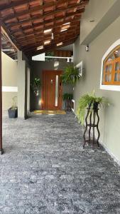 a hallway with potted plants in front of a building at Espaço Nobre in Cunha