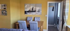 a dining room with a table and blue chairs at no 7 boutique apartment in Ulverston