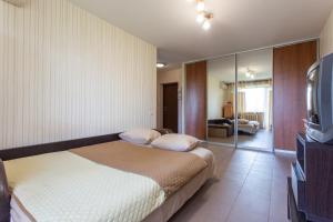 a hotel room with a bed and a television at Covent - Garden - Kharkiv in Kharkiv
