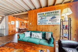 a living room with a green couch and a table at Lower Highlands Hideaway in Dover