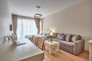 a living room with a couch and a table at Panorama Apartments New Gudauri in Gudauri