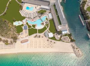 an aerial view of a resort next to the water at Porto Carras Meliton in Neos Marmaras