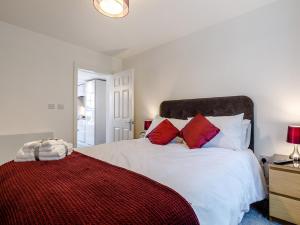 a bedroom with a white bed with red pillows at 1 Bed in Chester 78586 in Chester