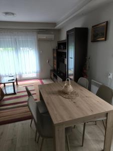 a dining room with a wooden table and chairs at Apartman - GOLEMI MOST in Pirot