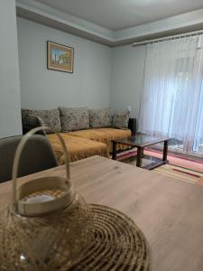 a living room with a couch and a table at Apartman - GOLEMI MOST in Pirot