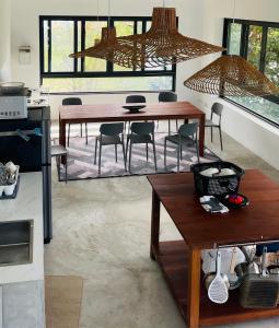 a kitchen with two tables and chairs in a room at ATATvilla Khaoyai with mountain rooftop view for party and BBQ in Mu Si