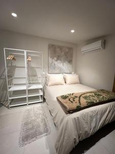 a bedroom with a bed and a book shelf at Lalola villas - Casa privada Denia in Denia